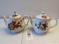 Front view of both Sadler teapots showing floral patterns and lids