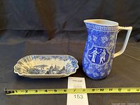 Dish and jug side by side with tape measure for scale