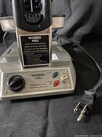 Front control panel showing brand badge, dial, lights, power cord