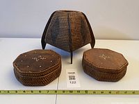 Front view showing woven tripod basket and two octagonal boxes