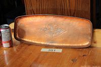 Full view of top of copper tray beside soda can for scale