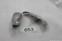 Both Hoselton aluminum sculptures, bear at left, goose at right, front view with lot reference number 653