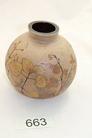 front view of spherical stoneware vase showing leaf motif