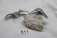 Two Hoselton aluminum goose sculptures, one on granite base