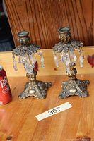 Full view of both brass candlestick holders with prisms