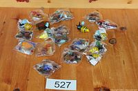 Group layout of all packaged bee and fish magnets on table