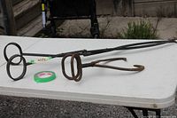 Both ice tongs side by side on table showing relative sizes