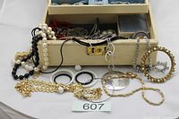 Open jewellery box showing mixed jewellery pieces laid out