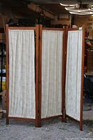 Full view of three-panel screen standing open outdoors