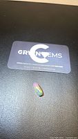 Gemstone on branded card showing size and identification