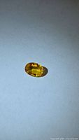 Oval yellow sapphire on neutral background