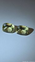 Two cushion-cut lemon citrine stones side by side