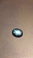 Front view of oval black star sapphire showing star effect