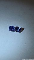 Front view of the two cushion cut tanzanite stones