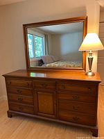 Full view dresser with mirror and lamp