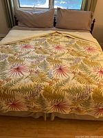 Full view of made king bed showing headboard posts and bedding