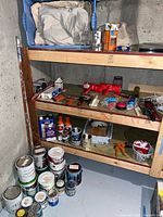 Shelf unit with paint cans, spray cans, caulk guns and accessories