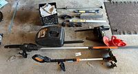 Entire lot laid out showing trimmer, pole saw, hedge trimmer, case, batteries and pole sections