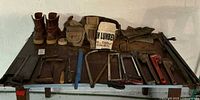 Overall view of all tools, boots, pouches on table