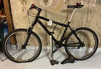 Side view of bike showing frame, wheels, floor pump, wheel chock