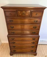 Front view showing entire highboy dresser with all nine drawers