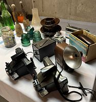 Overall lot showing five cameras, flash unit and leather case