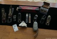 All thirteen tools laid out including planes, gauges, GEM box, Dowel-It box, tape measure pouch