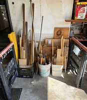 Crate and buckets of varied wood pieces flanked by black saw horses