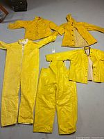 All five yellow garments laid flat showing types and fronts