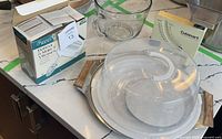 Full lot view showing cake carrier, tray, mixer box, glass measuring cup, scale