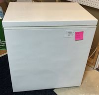 Front view of white chest freezer with closed lid