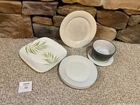 Group view of plates and bowl on carpet