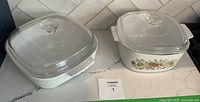 Both casserole dishes with lids displayed side by side