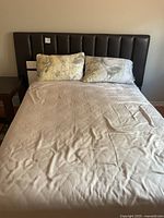 Full view of bed with leather headboard and mattress