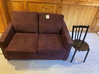 Front view of loveseat with chair at right