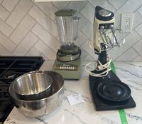 Blender, mixer and two stainless bowls on counter