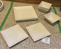 Entire dinnerware set laid out showing plates and bowls