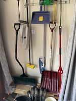 Overall shot of long-handled tools hanging and solar lights at bottom