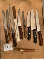 Full layout showing all nine knives and dagger scabbard