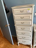 Front view showing six drawers, hardware, cabriole legs