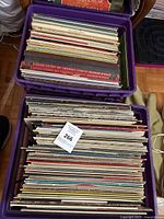 Two crates filled with vinyl records stored upright