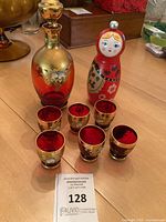 Group shot: decanter, six cordials, pepper mill