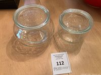 Two Weck glass jars side by side showing size difference and lids