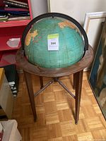 Full view of globe on mahogany four-leg stand