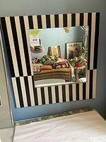 Front view of striped frame mirror showing full design