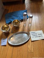 Group view of tray, two handled cups, two shakers, blue bag
