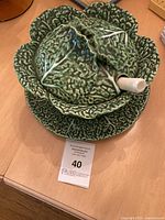 Closed cabbage tureen on underplate with ladle in place