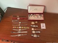 Full set of wristwatches laid out with Timex box