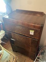 Front view of wood veneer waterfall cabinet showing drop-front and lower door