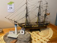 Side view of wooden sailing ship and lighthouse decor